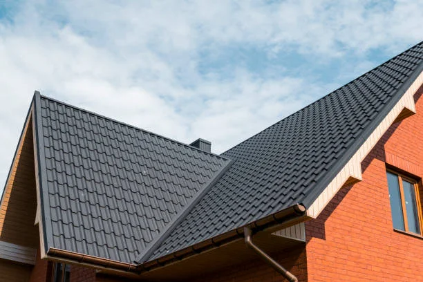 Dark gray metal roof on a red brick home with matching gutters, Washington, NC